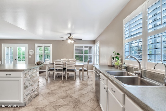 kitchen featuring french doors, stainless steel dishwasher, ceiling fan, sink, and white cabinetry