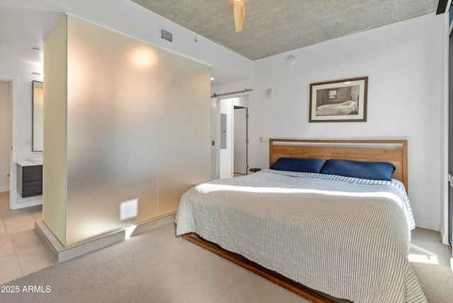 carpeted bedroom with a barn door