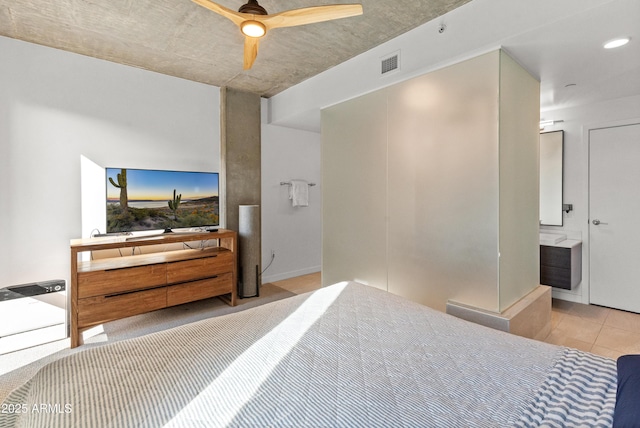 tiled bedroom with ensuite bathroom and ceiling fan