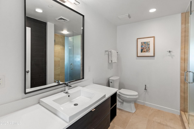 bathroom featuring vanity, a shower with shower door, tile patterned floors, and toilet