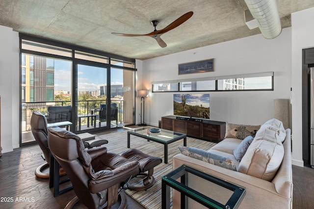 living room with expansive windows, ceiling fan, and dark hardwood / wood-style floors