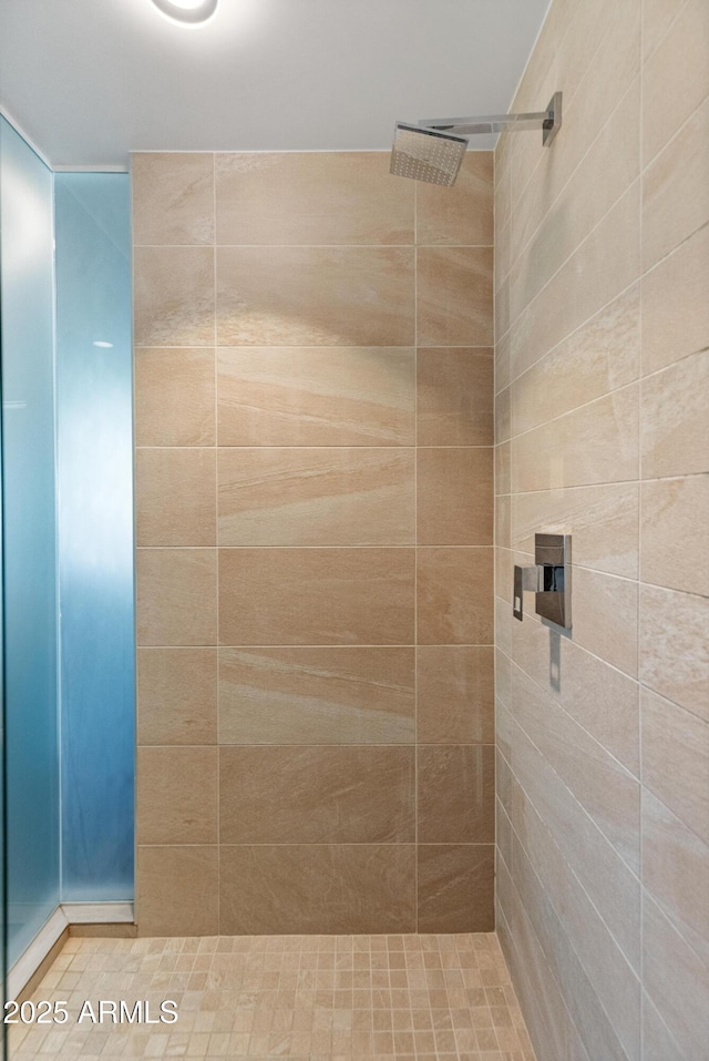 bathroom with tiled shower