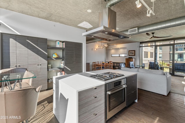 kitchen with pendant lighting, island range hood, a center island, stainless steel appliances, and dark wood-type flooring