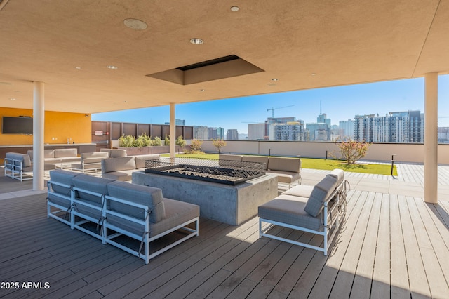 wooden deck with an outdoor living space with a fire pit