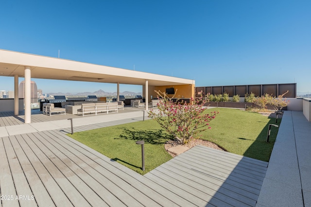 deck with a lawn and outdoor lounge area