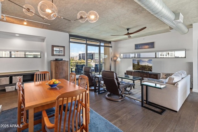 dining area with rail lighting, floor to ceiling windows, dark hardwood / wood-style floors, and ceiling fan