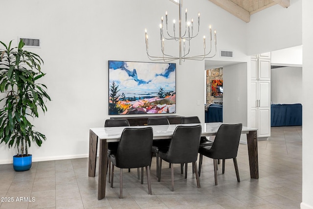 dining space with beam ceiling, visible vents, a towering ceiling, and baseboards