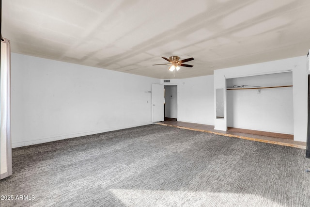 unfurnished bedroom with carpet flooring, ceiling fan, and a closet