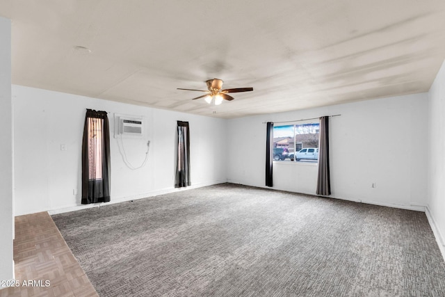 spare room with a wall mounted air conditioner and ceiling fan