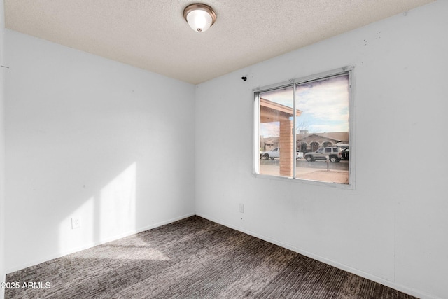 spare room with carpet floors and a textured ceiling