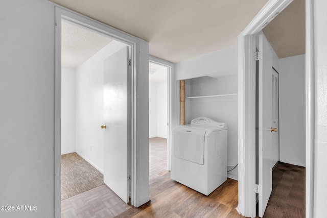 washroom with washer / dryer and light hardwood / wood-style flooring