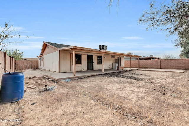 back of house featuring central air condition unit and a patio area