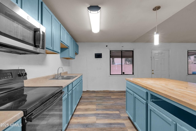 kitchen with blue cabinets, sink, decorative light fixtures, and black electric range