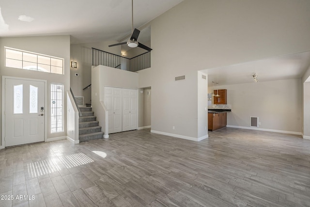 1610 W Maplewood St, Chandler, AZ 85286 - entrance foyer with baseboards, stairs, wood finished floors, high vaulted ceiling, and a ceiling fan