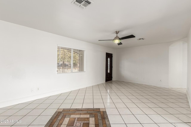 empty room with light tile patterned floors and ceiling fan