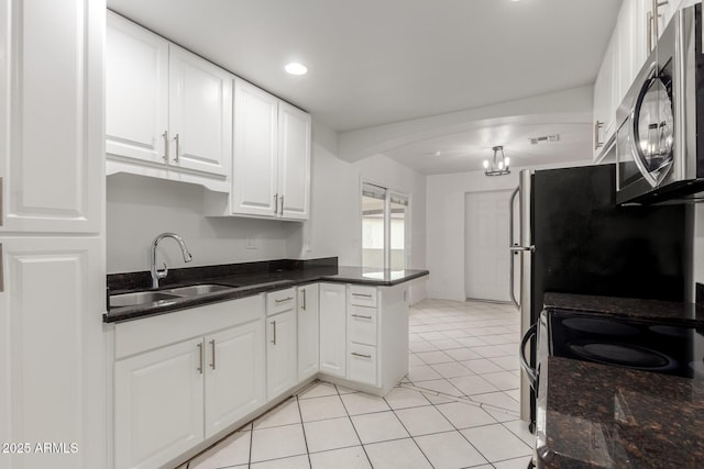 kitchen featuring pendant lighting, sink, light tile patterned floors, white cabinets, and kitchen peninsula