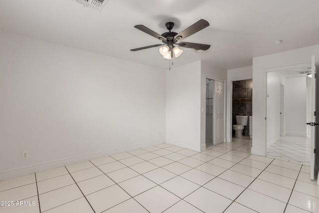 empty room with ceiling fan and light tile patterned flooring