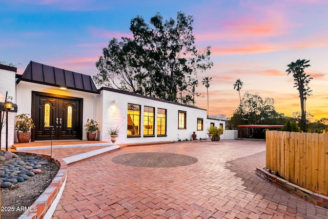 view of back house at dusk