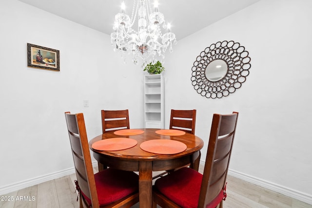 dining space featuring a chandelier and light hardwood / wood-style floors