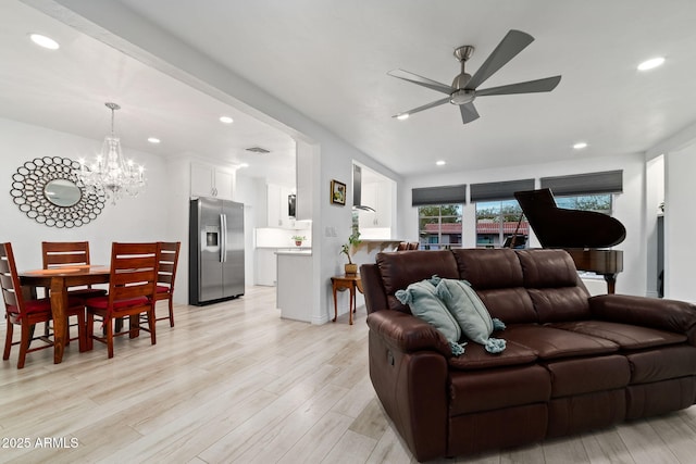 living room featuring ceiling fan and light wood-type flooring