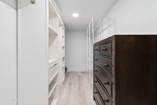 walk in closet featuring light hardwood / wood-style flooring