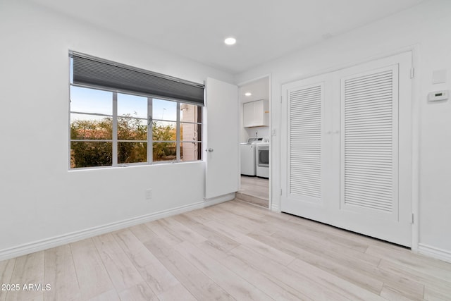 interior space with washer / clothes dryer and light hardwood / wood-style flooring