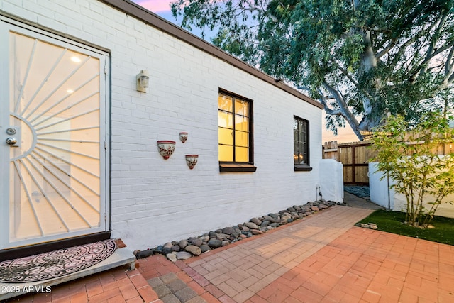 property exterior at dusk with a patio