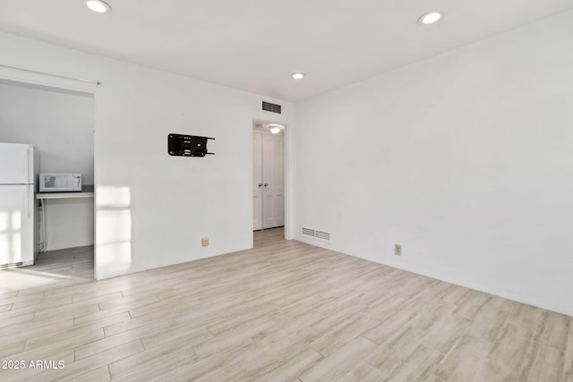 empty room with light hardwood / wood-style floors