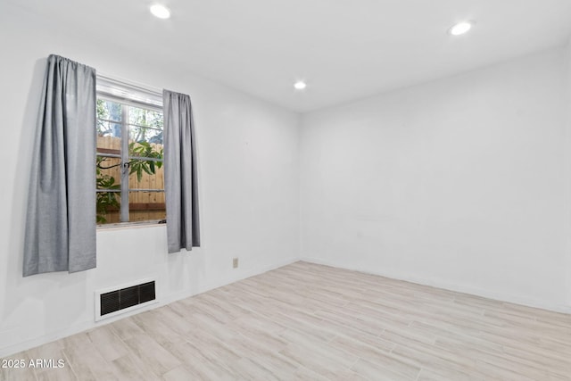 spare room with light hardwood / wood-style flooring