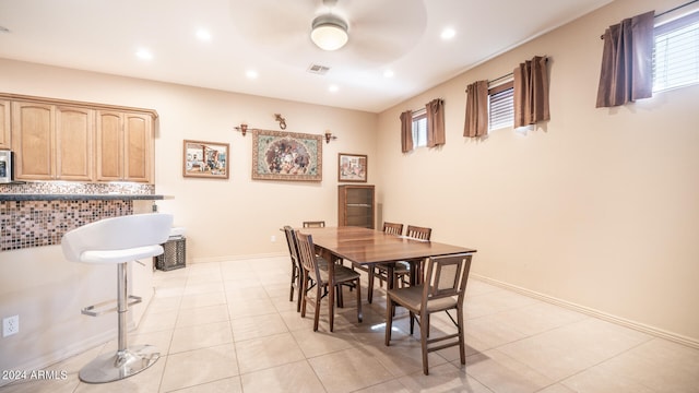 dining room featuring a healthy amount of sunlight, light tile patterned floors, and ceiling fan