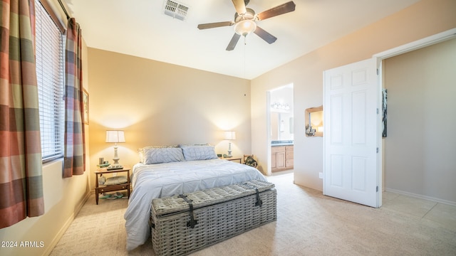 carpeted bedroom with connected bathroom and ceiling fan