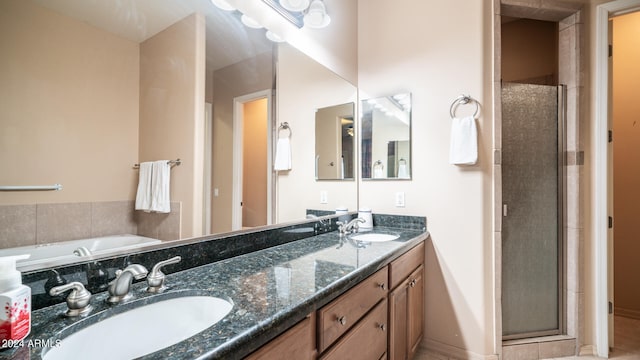 bathroom with vanity and separate shower and tub