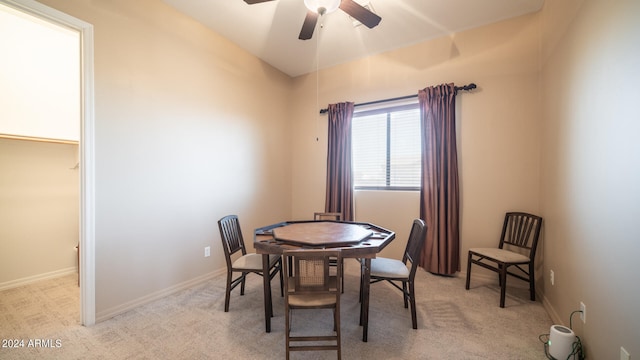 dining room with light colored carpet and ceiling fan