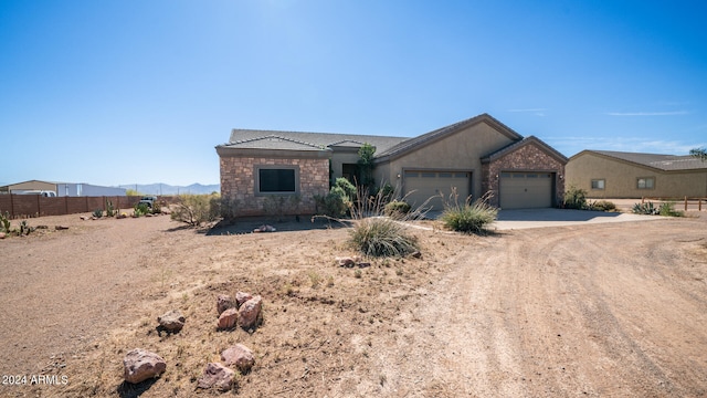 view of front facade with a mountain view and a garage