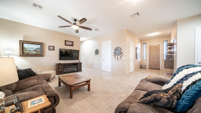 living room featuring light tile patterned flooring and ceiling fan