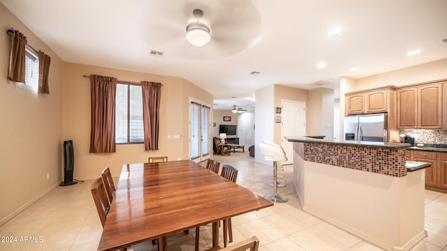 tiled dining room with ceiling fan