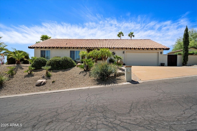 16804 E Monterey Dr, Fountain Hills, AZ 85268 - mediterranean / spanish-style home featuring a tiled roof, a garage, stucco siding, and driveway