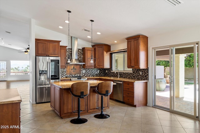 16804 E Monterey Dr, Fountain Hills, AZ 85268 - kitchen with visible vents, appliances with stainless steel finishes, wall chimney range hood, and tasteful backsplash