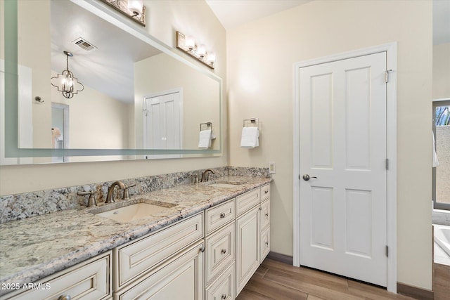 16804 E Monterey Dr, Fountain Hills, AZ 85268 - bathroom with double vanity, visible vents, a sink, and wood finished floors
