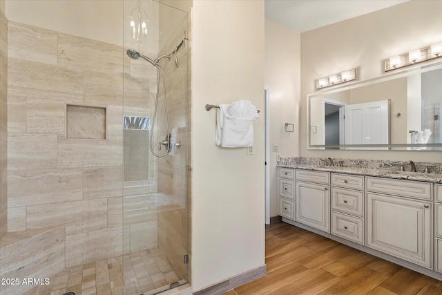 16804 E Monterey Dr, Fountain Hills, AZ 85268 - bathroom with wood finished floors, double vanity, a sink, and a stall shower