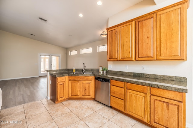 kitchen with french doors, kitchen peninsula, sink, stainless steel dishwasher, and light wood-type flooring