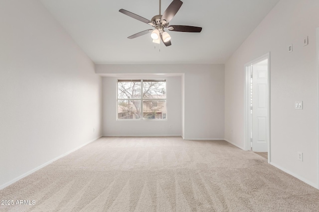 carpeted empty room featuring baseboards and ceiling fan