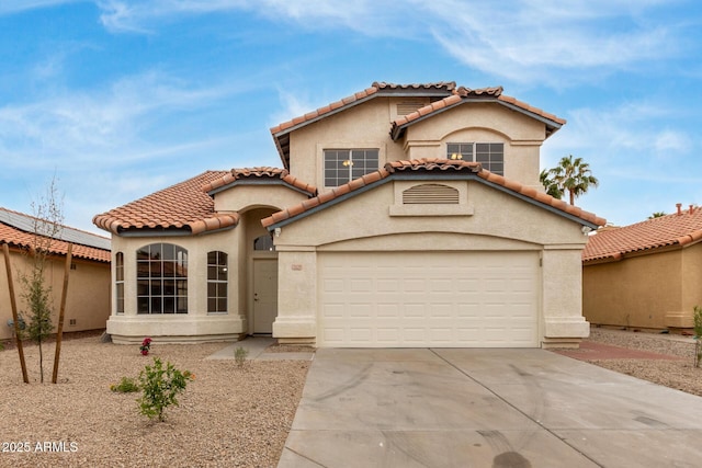 mediterranean / spanish-style house with stucco siding, driveway, and a tiled roof