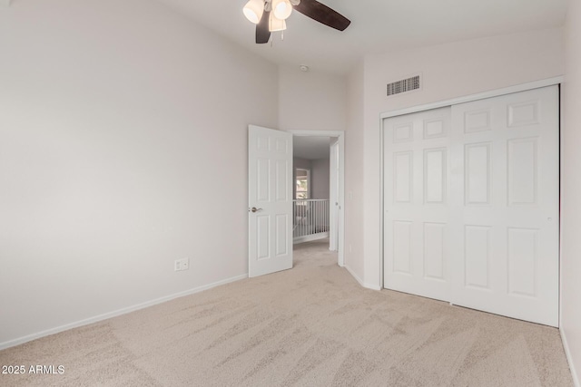 unfurnished bedroom featuring visible vents, carpet flooring, baseboards, and vaulted ceiling