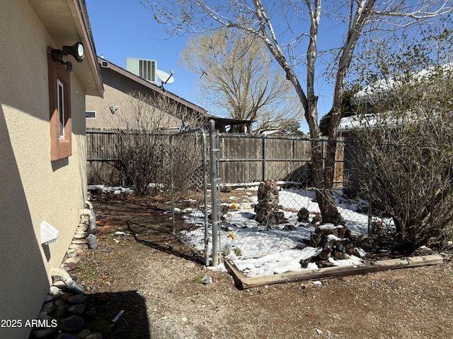 snowy yard with fence