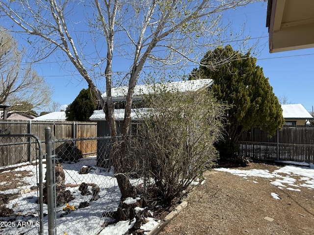 snowy yard featuring fence private yard