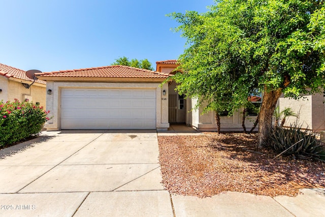 8341 W Cypress St, Phoenix, AZ 85037 - view of front of property with driveway, stucco siding, an attached garage, and a tile roof