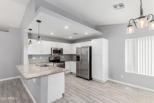 8341 W Cypress St, Phoenix, AZ 85037 - kitchen with stainless steel appliances, a peninsula, light stone counters, white cabinetry, and light wood finished floors