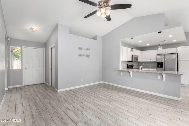 8341 W Cypress St, Phoenix, AZ 85037 - kitchen with appliances with stainless steel finishes, lofted ceiling, a peninsula, a ceiling fan, and white cabinets