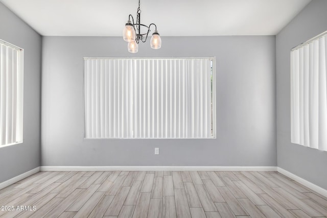 8341 W Cypress St, Phoenix, AZ 85037 - spare room with wood finished floors and a chandelier